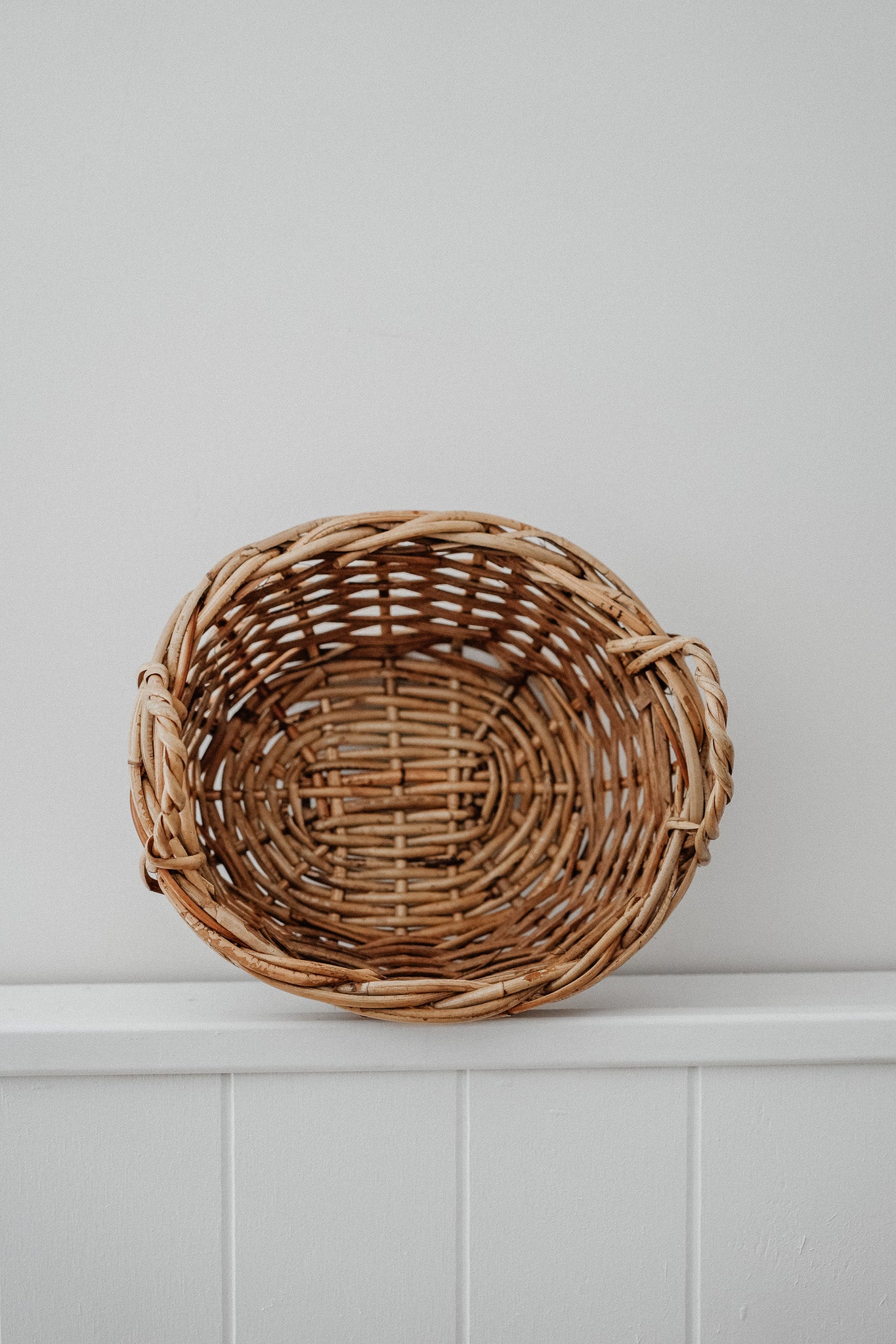 Oval cane basket with side handles