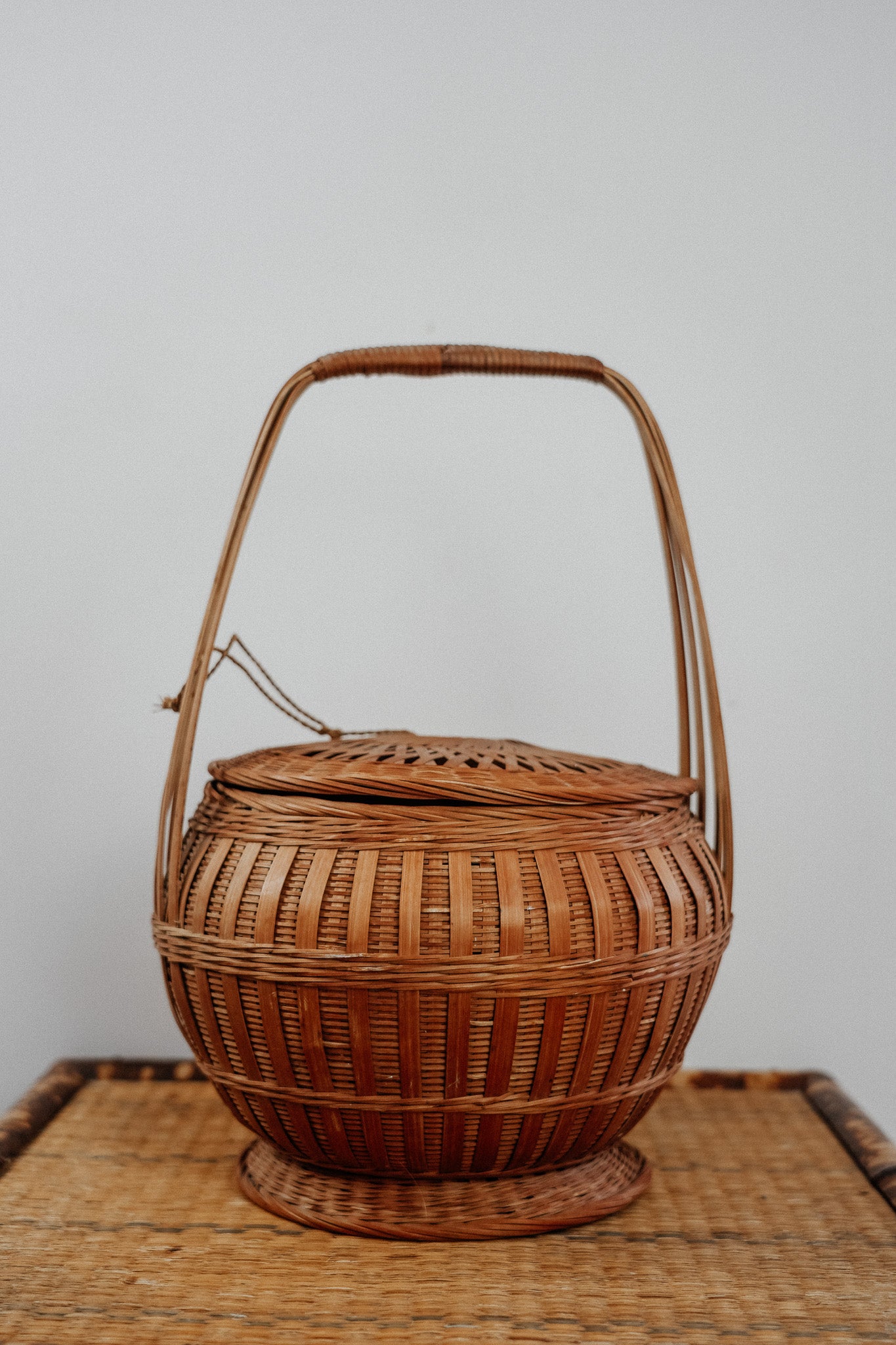 Woven basket with tie on lid