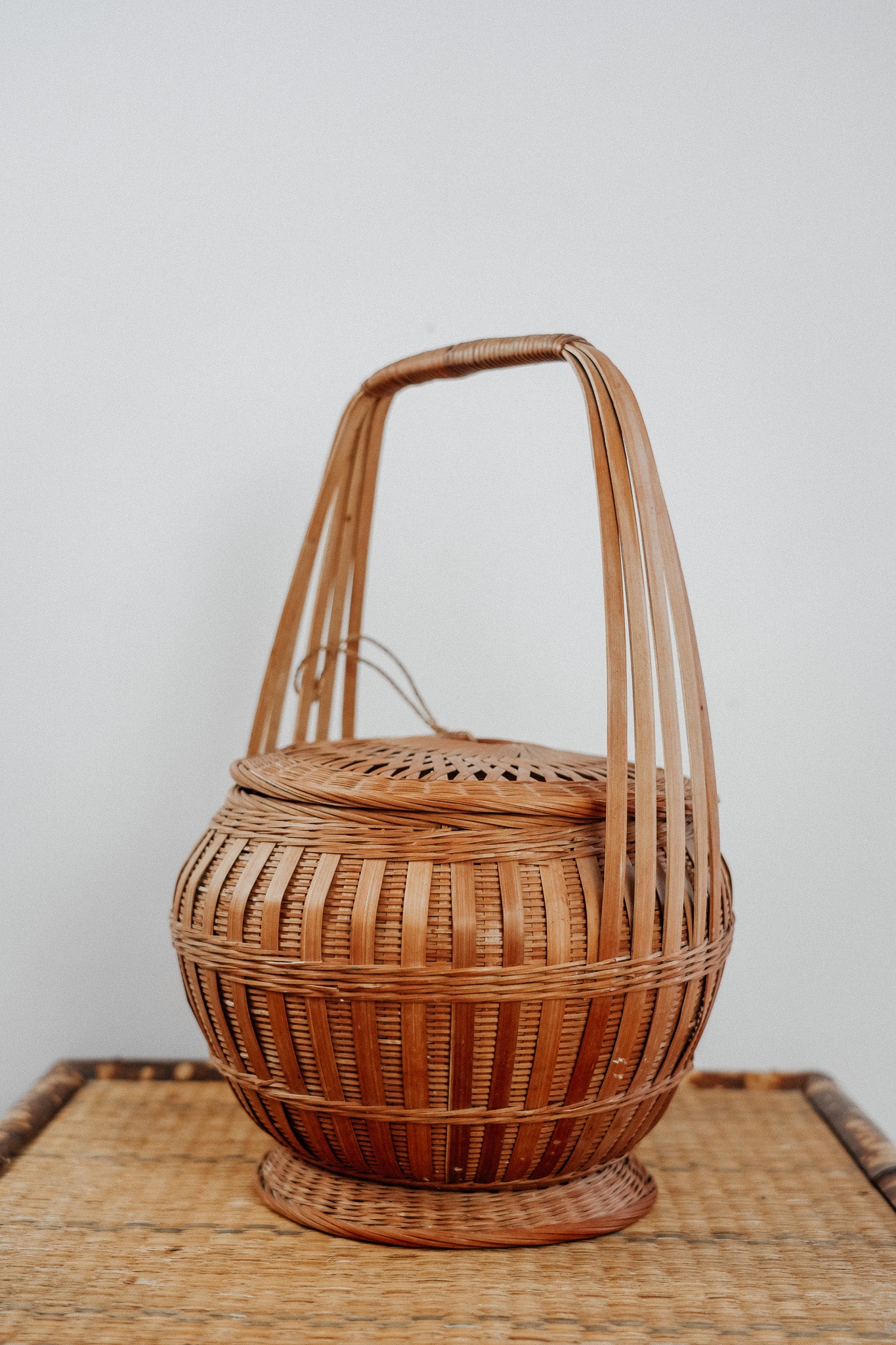 Woven basket with tie on lid