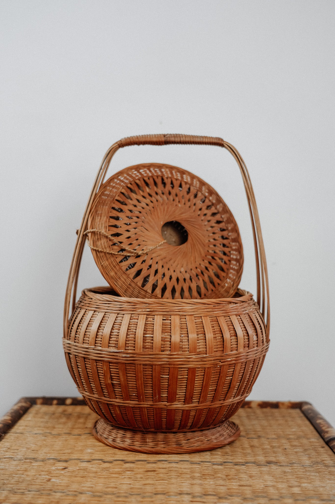 Woven basket with tie on lid