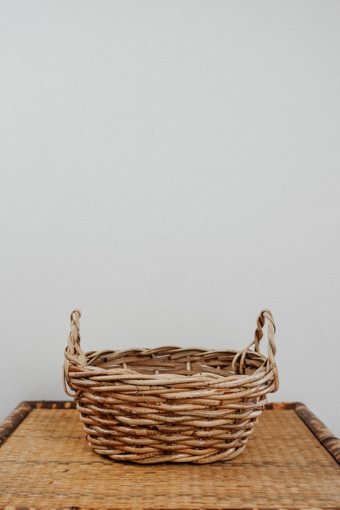 Oval cane basket with side handles