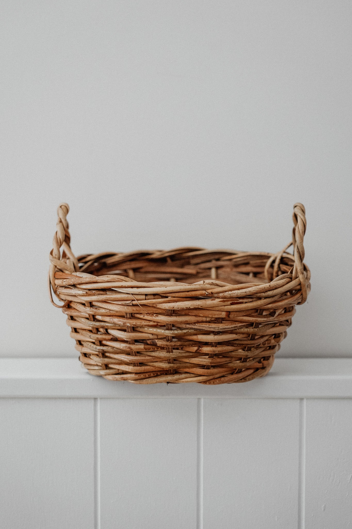 Oval cane basket with side handles